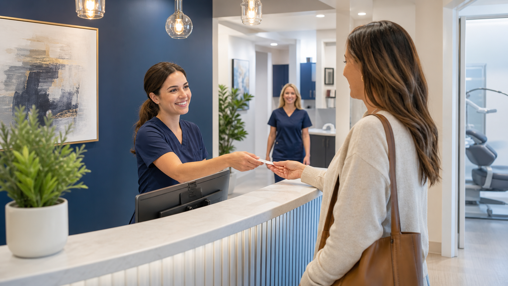 Dental front desk team welcoming a patient